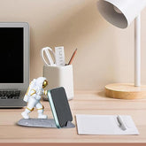 Mobliq-Delivering smiles to India, NYRWANA is a creative astronaut statue for your home office that can hold your phone, tablet, and cell phone.