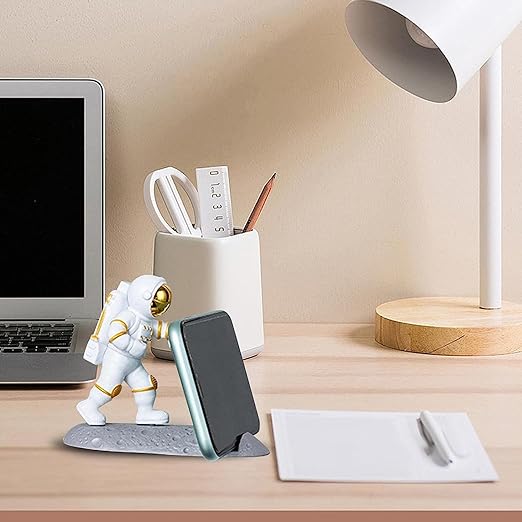 Mobliq-Delivering smiles to India, NYRWANA is a creative astronaut statue for your home office that can hold your phone, tablet, and cell phone.